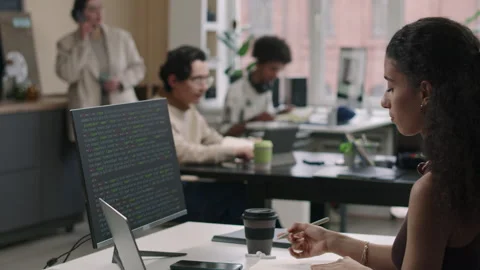 Young Female Programmer Analyzing Program Code on Desktop Computer in Office Stock Footage 274337888