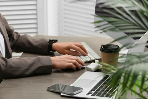 Young female programmer with computer, cup of coffee and laptop working in of Stock Photos