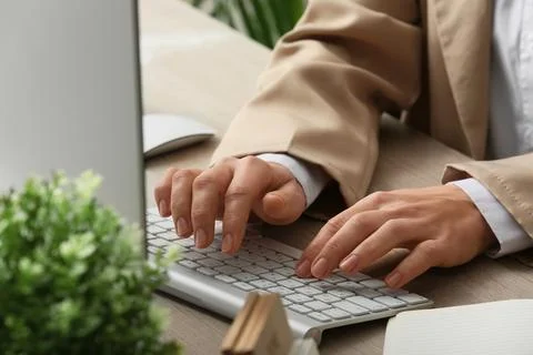 Young female programmer with computer typing on keyboard in office, closeup Stock Photos