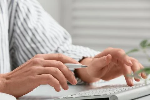 Young female programmer with computer typing on keyboard in office, closeup Stock Photos