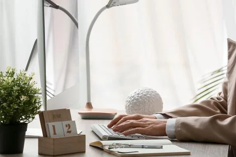 Young female programmer with computer typing on keyboard in office, closeup Stock Photos