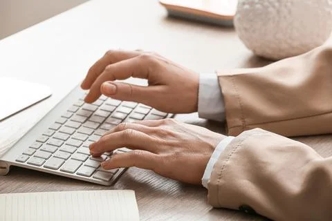 Young female programmer with computer typing on keyboard in office, closeup Stock Photos