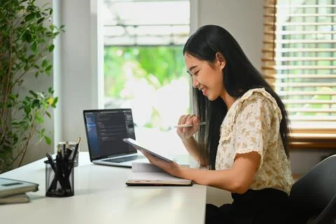 Young female programmer freelancer coding scripts java language, checking Stock Photos