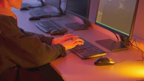 A young female programmer gets to work and quickly writes code on a PC. Stock Footage 146662854