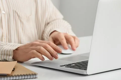 Young female programmer with laptop and notebooks working in office, closeup Stock-Fotos