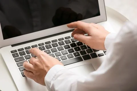 Young female programmer with laptop working in office, closeup Stock Photos
