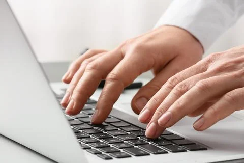 Young female programmer with laptop working in office, closeup Stock-Fotos