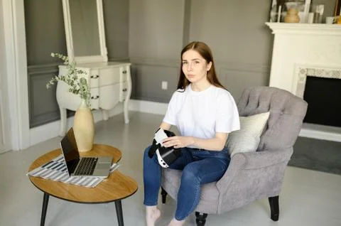 Young female programmer testing a new app with virtual reality glasses in home Fotos Stock
