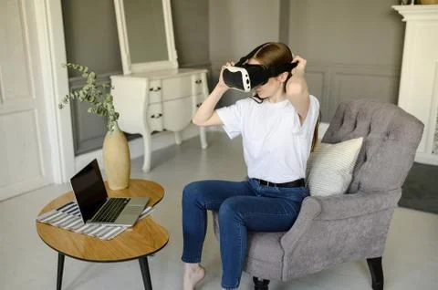 Young female programmer testing a new app with virtual reality glasses in home Stock-Fotos