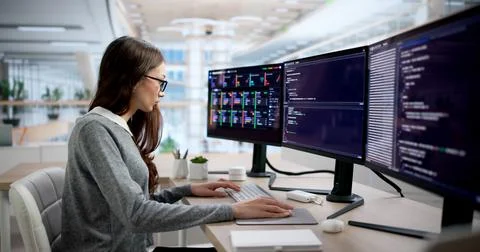 Young Female Programmer Typing Code While Monitoring Cloud System Alerts. Stock Photos
