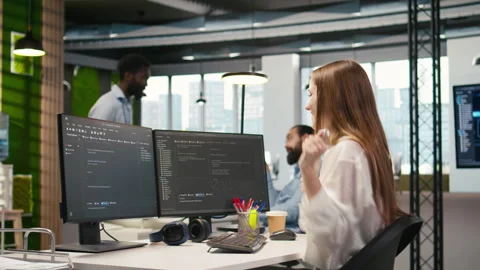 Young female programmer uses computer to write code, developing machine learning Stock Footage 313164921
