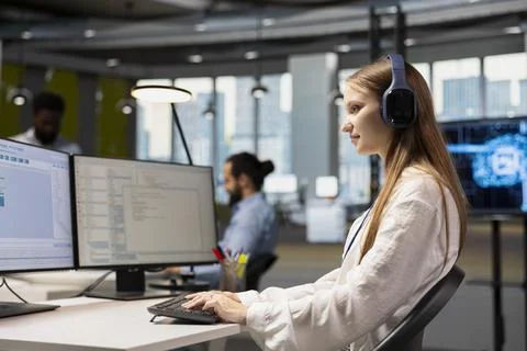 Young female programmer at work training machine learning models Stock Photos