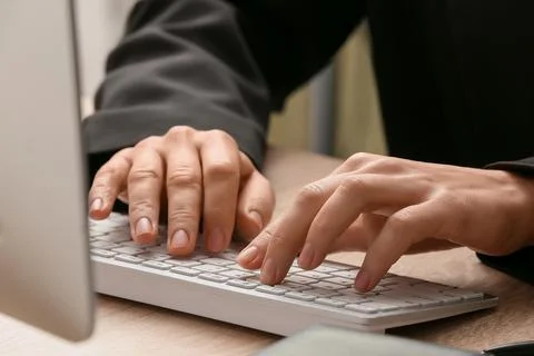 Young female programmer working with computer in office, closeup Stock Photos