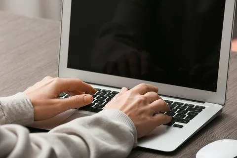 Young female programmer working with laptop in office, closeup Stock Photos