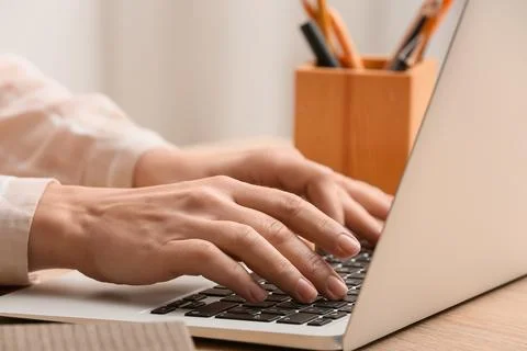Young female programmer working with laptop in office, closeup Stock Photos