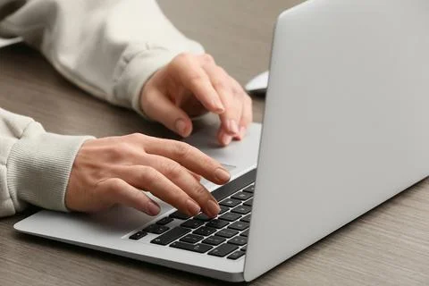 Young female programmer working with laptop in office, closeup Stock Photos