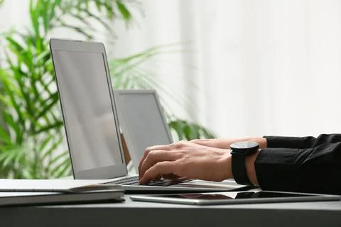 Young female programmer working with laptop in office, closeup Stock Photos