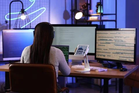 Young female programmer working with laptop and tablet computer in modern off 스톡 사진