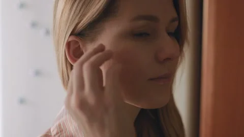 Young female pull out her hearing aid from her right ear, close up,50 fps Stock Footage 85567931