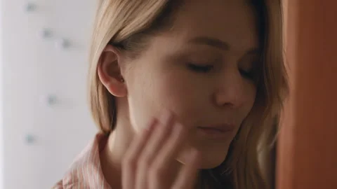 Young female pull out her hearing aid from her right ear, close up,50 fps Stock Footage 85568521
