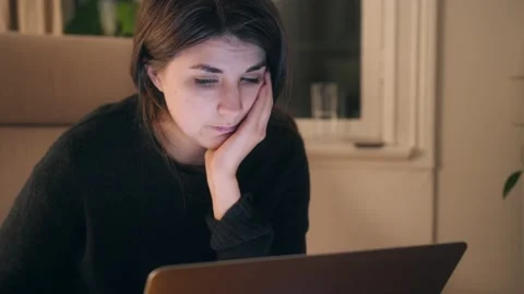 Young Female react with excitement while internet shopping for Clothes On Laptop Stock Footage 144030426