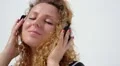 Young Female Relaxing in Headphones Listening Music. Slow Motion. HD Footage