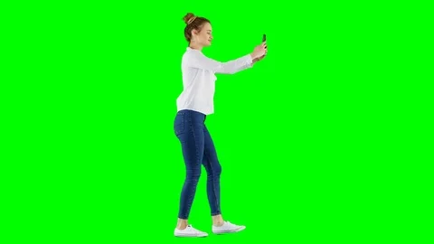 Young Female Replying To a SMS Text Message While Walking on Green Screen Video stock 124608868