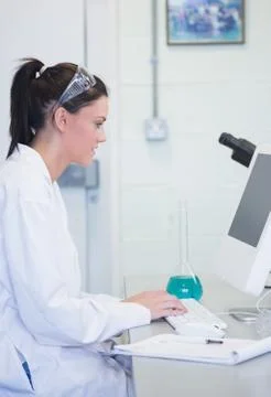 Young female researcher using computer in lab Stock Photos