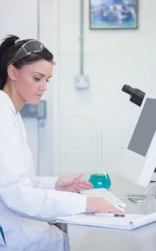 Young female researcher using computer in lab Stock Photos