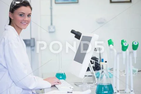 Young female researcher using computer in lab Stock Photos