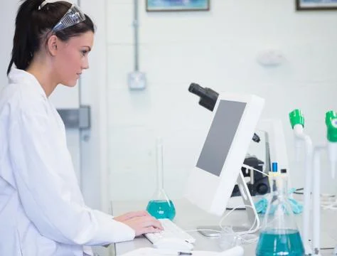 Young female researcher using computer in lab Stock Photos