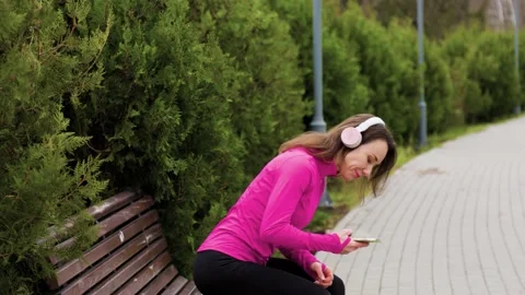 A young female runner jogging through a parkway on Stock Footage 234693205