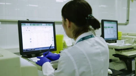 Young Female Scientist Enters Data Into the Computer For Analysis Touchscreen. Stock Footage