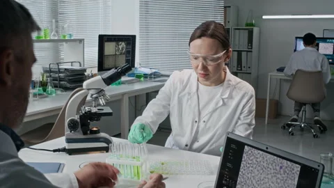 Young Female Scientist Looking in Microscope in Lab Timelapse Stock Footage 330675783