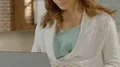 Young female sitting on couch and typing on laptop, smiling, dating website HD Footage