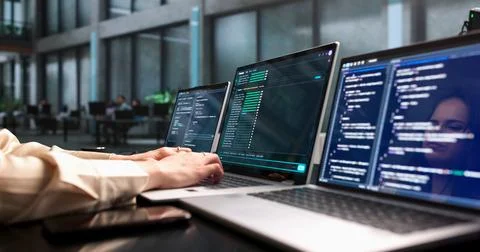 Young Female Software Developer Coding Secure Cloud Projects On Laptop. Stock Photos