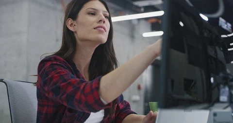 Young female software developer using laptop computer while writing programmi Stock Footage 113955324
