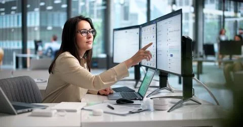 Young Female Software Engineer Uses Laptop To Analyze AI Knowledge Base Data. Stock Photos