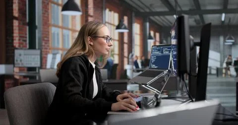 Young Female Software Engineer Working On Secure Coding At Modern Office Desk Stock Photos