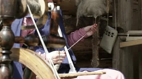 Young female spinning yarn. Stock Footage