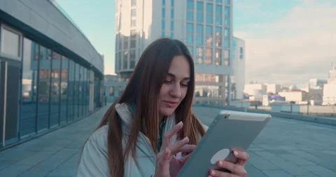 Young female student with tablet computer in the city. Female is typing Stock Footage 164839341