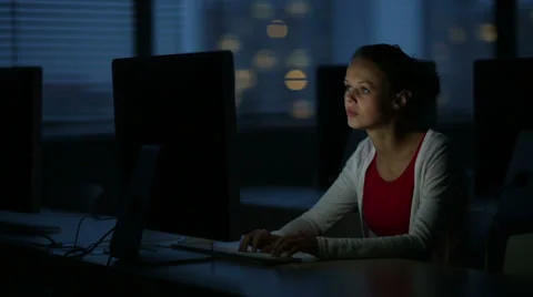 Young female student working alone in a computer classroom Stock Footage 33763846