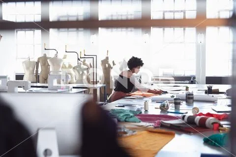 Young female student working on a project at a fashion college Stock Photos