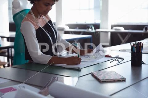 Young female student working on projects at a fashion college Stock Photos