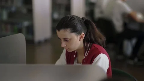 Young Female Student Working Studying in Library at Desk Vídeos de archivo 127614832
