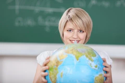 Young female student with a world globe Stock Photos