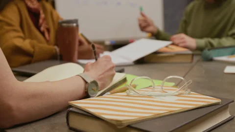 Young Female Student Writing in Notebook Studying in Group Language Class Stock Footage 323188260