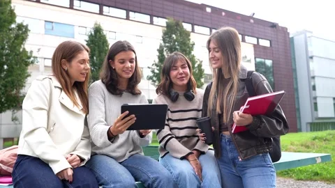 Young female students studying together using a tablet computer Stock Footage 332872890