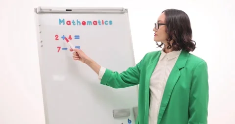 Young female teacher explains basic mathematics equations Video stock 310215764