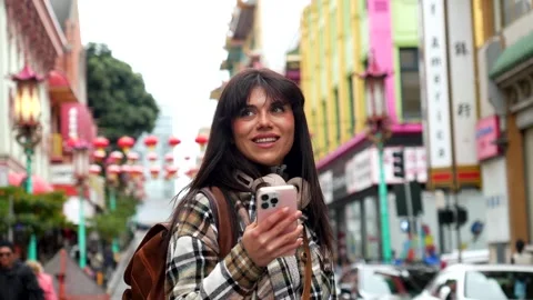 Young female tourist using smartphone in san francisco's chinatown Stock Footage 333105584
